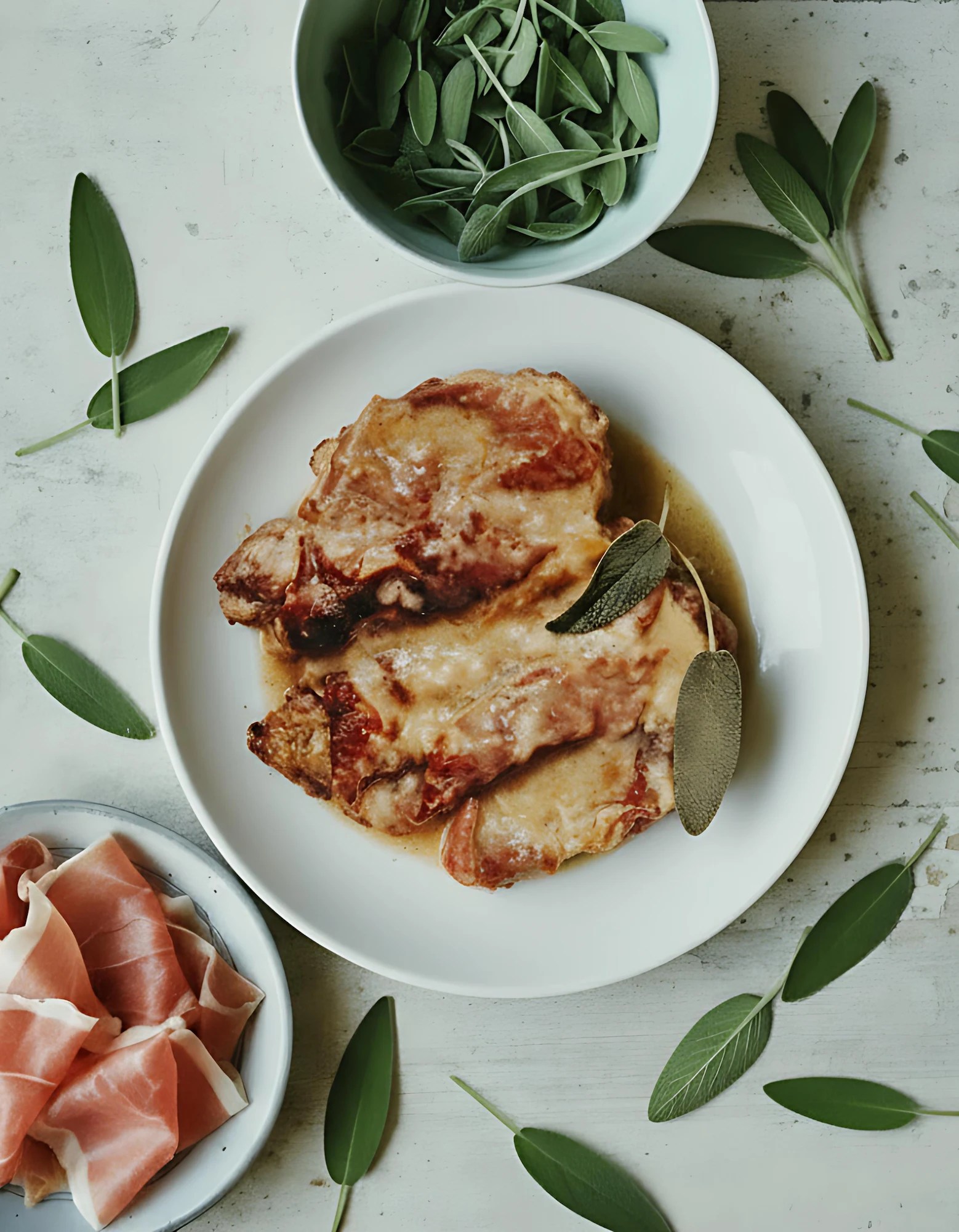 Meat with sauce and sage leaves