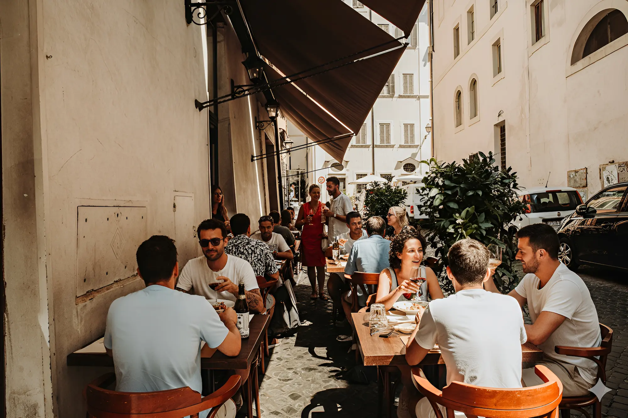 Guests raising a toast at outdoor tables